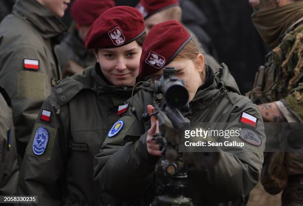Female Polish military cadet looks through the sight of a British sniper rifle during the NATO Dragon 24 military exercise on March 04, 2024 near...