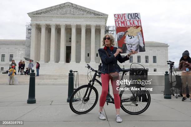 Local resident Nicky Sundt holds a sign that read “Save Our Democracy” in front of the U.S. Supreme Court on March 4, 2024 in Washington, DC. The...