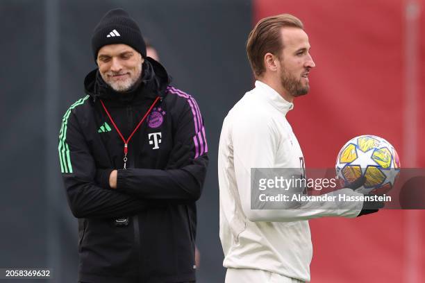 Thomas Tuchel, Head Coach of FC Bayern München looks on next to his player Harry Kane during a training session ahead of their UEFA Champions League...