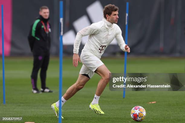 Thomas Müller of FC Bayern München plays with the ball during a training session ahead of their UEFA Champions League Round of 16 second leg match at...