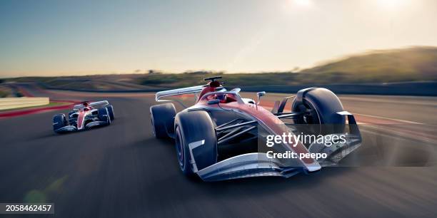 racing cars driven at high speed on race track - racewagen stockfoto's en -beelden