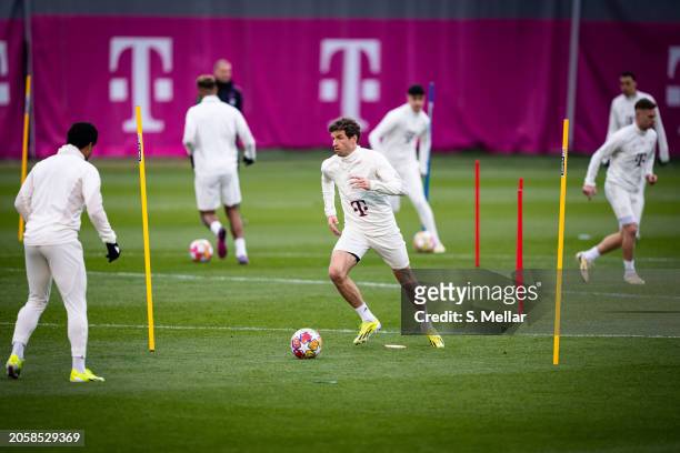 Thomas Mueller of FC Bayern Muenchen controls the ball during a training session ahead of their UEFA Champions League Round of 16 second leg match at...
