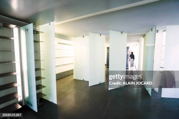 Woman walks away from the living room during a press visit in Paris on March 7 of the futuristic 260 m2 three-room apartment with a 50 m2 dressing...