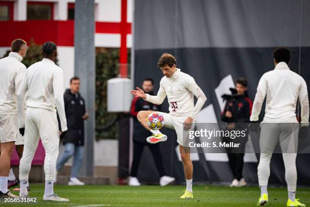 Thomas Mueller of FC Bayern Muenchen controls the ball during a training session ahead of their UEFA Champions League Round of 16 second leg match at...