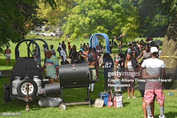 Food cooks on a grill as people enjoy the first Elijah Cancer Day Carnival at Krank Park on Monday, June 24, 2019 in Albany, N.Y.