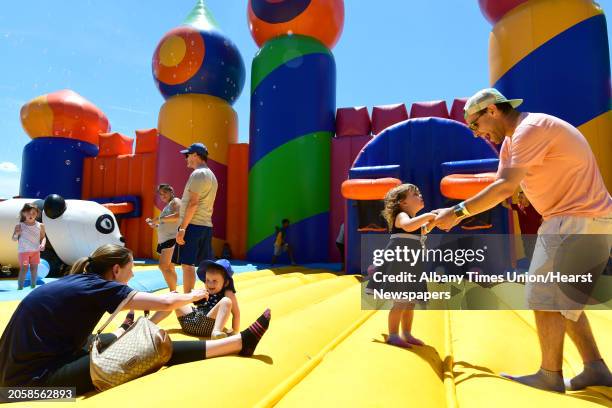 Bridget Canary of Charlton, left, plays with her daughter Caroline while Dylan Spring of Albany, right, plays with his daughter Everleigh as The Big...