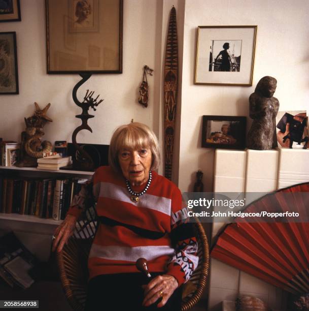 Argentine born British painter and photographer Eileen Agar seated in the living room of her house in England in 1984.