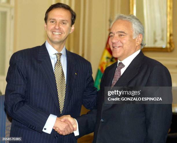 Bolivian President, Jorge Quiroga , greets the most favored presidential candidate of the last polls, Gonzalo Sanchez Lozada, on 30 July 2002 at the...