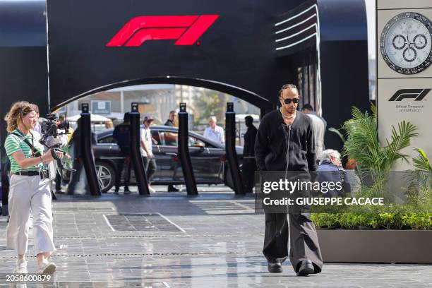 Mercedes' British driver Lewis Hamilton walks to the paddock ahead of the first practice session of the Saudi Arabian Formula One Grand Prix at the...