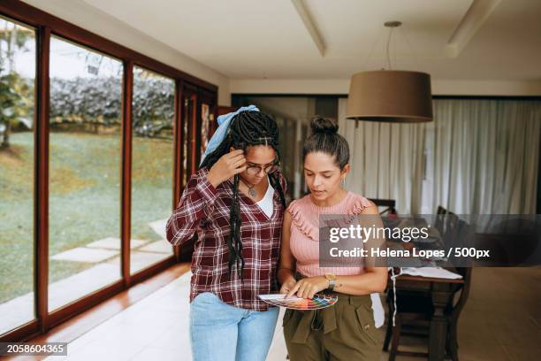 couple looking at each other while standing by window at home,belo horizonte,state of minas gerais,brazil - belo horizonte brazil stock pictures, royalty-free photos & images