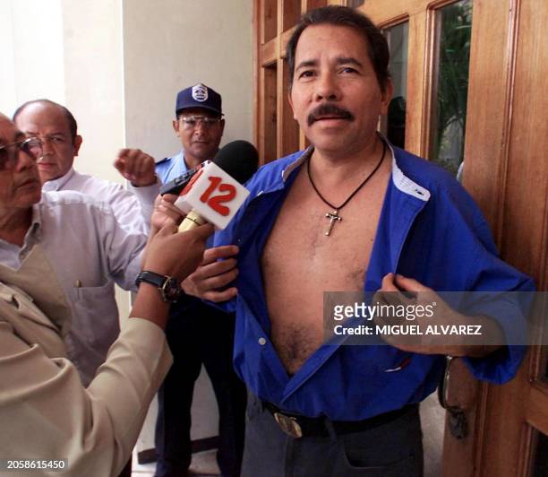 Former Nicaraguan President and current presidential candidate Daniel Ortega with the Sandinista Front of National Liberation opens his shirt to show...