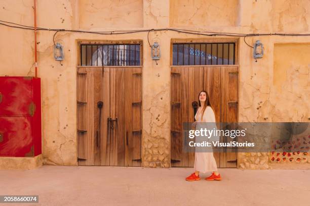 woman traveler exploring old town of dubai city - al fahidi fort stock pictures, royalty-free photos & images