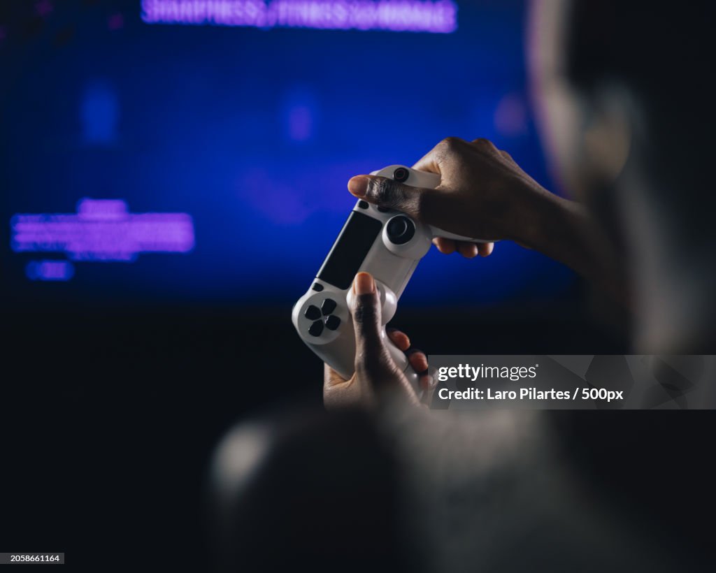 Close-up over the shoulder view of man playing video game at home,Corpus Christi,Texas,United States,USA