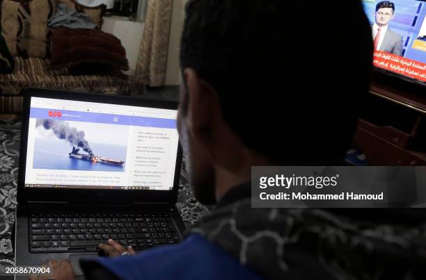 Man follows news about the recent Houthi attacks on ships, on March 4, 2024 in Sana'a, Yemen. The military spokesperson of Yemen's Houthi group...