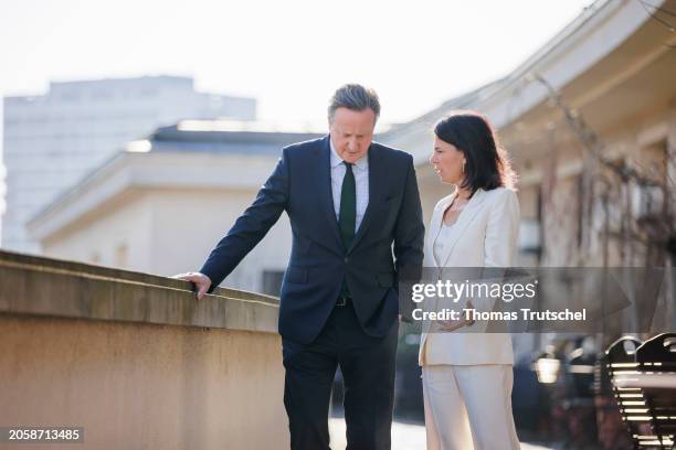 Annalena Baerbock, German Foreign Minister, and Britain's Foreign Secretary David Cameron chats during her meeting on March 07, 2024 in Berlin,...