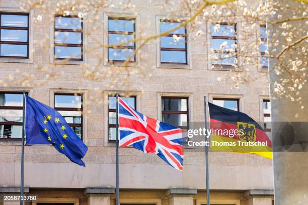 The flags of European Union, Great Britain and Germany wave in the wind on March 07, 2024 in Berlin, Germany.