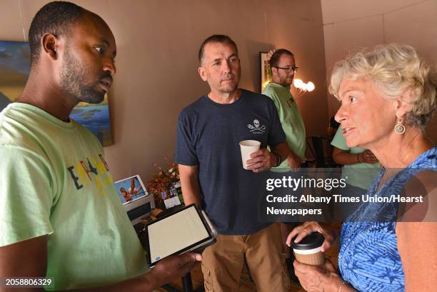 Susan Gallagher of Troy, right, talks to Belayneh Woldemariam of Ethiopia as Empower Ethiopian hosted a conversation and cultural exchange at Happy...