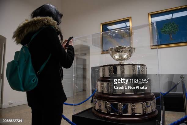 Woman taking a photo to Davis Cup trophy is seen during Italian Trophy Tour in L'Aquila, Italy, on March 1st, 2024. Italy won 2023 Davis Cup against...