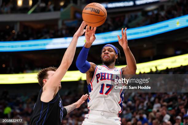 Buddy Hield of the Philadelphia 76ers is defended by Luka Doncic of the Dallas Mavericks during the first half at American Airlines Center on March...
