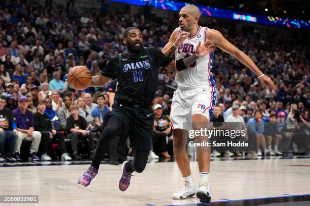 Kyrie Irving of the Dallas Mavericks is defended by Nicolas Batum of the Philadelphia 76ers during the second half at American Airlines Center on...