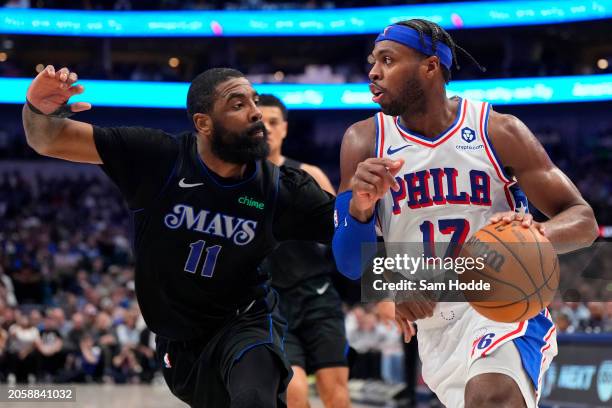 Buddy Hield of the Philadelphia 76ers is defended by Kyrie Irving of the Dallas Mavericks during the first half at American Airlines Center on March...