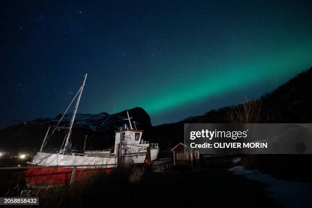 This picture shows northern lights In Maervoll near Unstad on March 3, 2024 in Lofoten Islands.