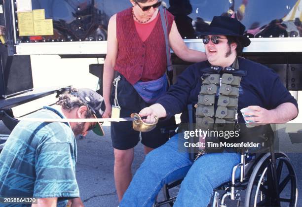 John Popper of Blues Traveler knights a crew member during Laguna Seca Daze at Laguna Seca Racetrack on May 28, 1995 in Monterey, California.