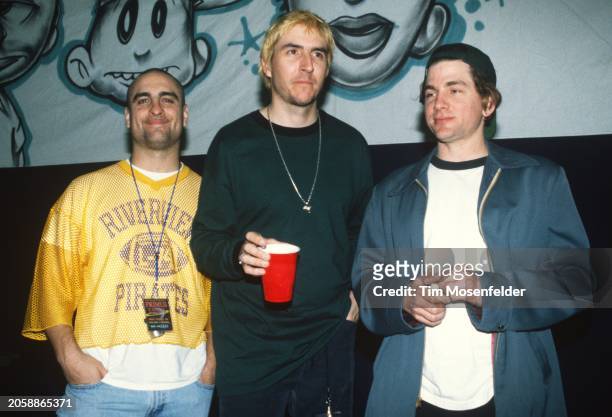 Tim Alexander, Les Claypool, and Larry LaLonde pose at Oakland Coliseum Arena on December 31, 1995 in Oakland, California.