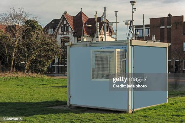 air quality measuring station is located outside on a lawn in a residential area - temperature sensor stock pictures, royalty-free photos & images