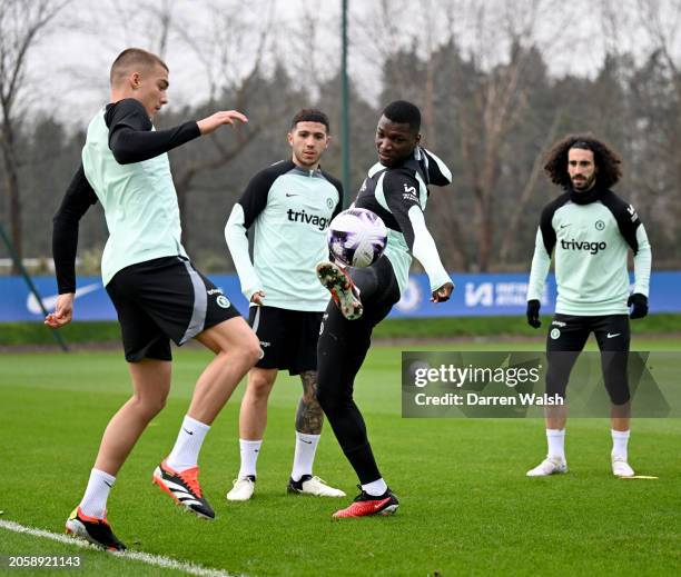 Alfie Gilchrist, Enzo Fernandez and Moises Caicedo of Chelsea during a training session at Chelsea Training Ground on March 7, 2024 in Cobham,...