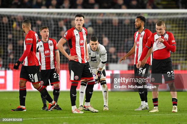 Players of Sheffield United look dejected after Gabriel Martinelli of Arsenal scores his team's third goal during the Premier League match between...