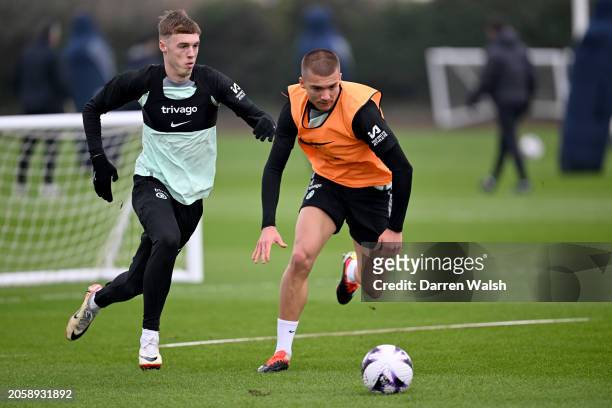 Cole Palmer and Alfie Gilchrist of Chelsea during a training session at Chelsea Training Ground on March 7, 2024 in Cobham, England.