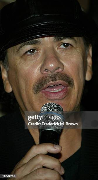 Recording artist Carolos Santana speaks during a press conference at the Creative Artist Agency announcing proceeds from Santana's entire summer 2003...