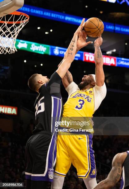 Los Angeles Lakers forward Anthony Davis is fouled by Sacramento Kings center Alex Len while putting up a short jumper in the first half on March 6,...