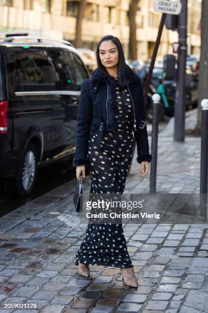Shanina Shaik wears navy shearling jacket, dress with dots print, bag outside Stella McCartney during the Womenswear Fall/Winter 2024/2025 as part of...