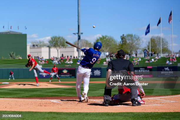 Matt Duffy of the Texas Rangers flies out in the second inning during a spring training game against the Los Angeles Angels at Surprise Stadium on...