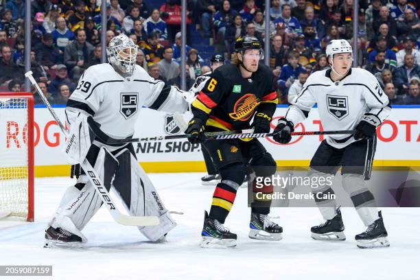 Cam Talbot and Jordan Spence of the Los Angeles Kings defend against Brock Boeser of the Vancouver Canucks during the first period of the NHL game at...