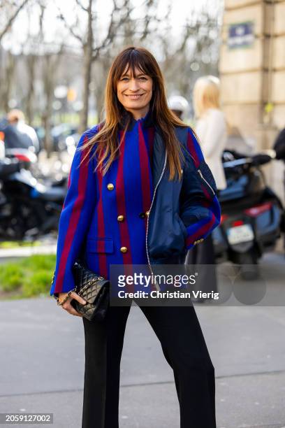 Caroline de Maigret wears asymmetric, red blue striped jacket, Chanel bag, black pants outside Sacai during the Womenswear Fall/Winter 2024/2025 as...