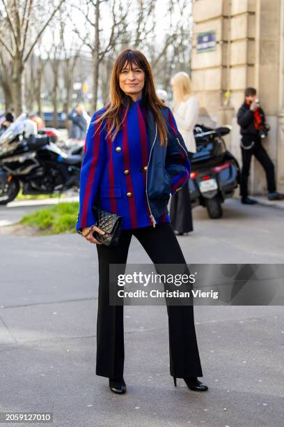 Caroline de Maigret wears asymmetric, red blue striped jacket, Chanel bag, black pants outside Sacai during the Womenswear Fall/Winter 2024/2025 as...