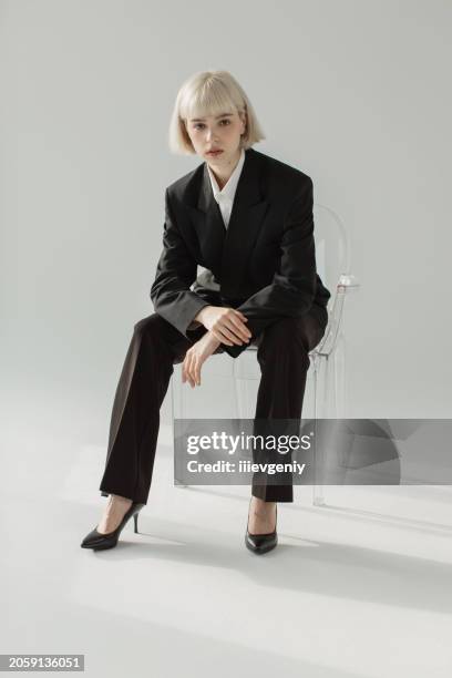 blonde woman in black suit in studio. fashion model. - sessão fotográfica imagens e fotografias de stock