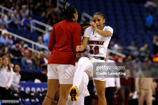 Jayda Curry of the Louisville Cardinals celebrates with a teammate following their game against the Boston College Eagles in the Second Round of the...