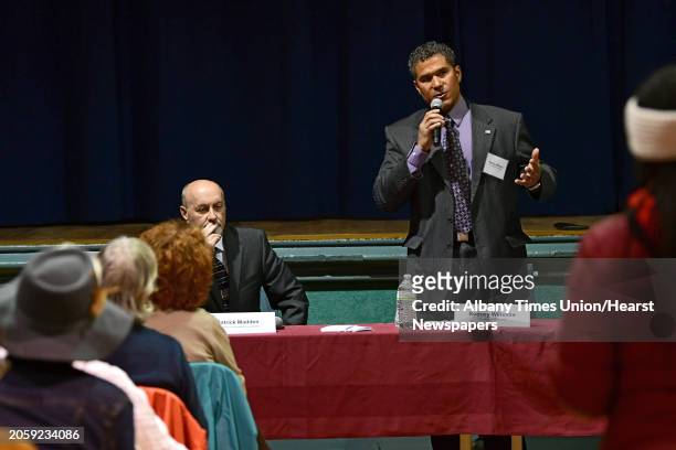 Rodney Wiltshire, a former council president, right, speaks during a mayoral debate with Mayor Patrick Madden at Troy Prep Elementary on Wednesday,...