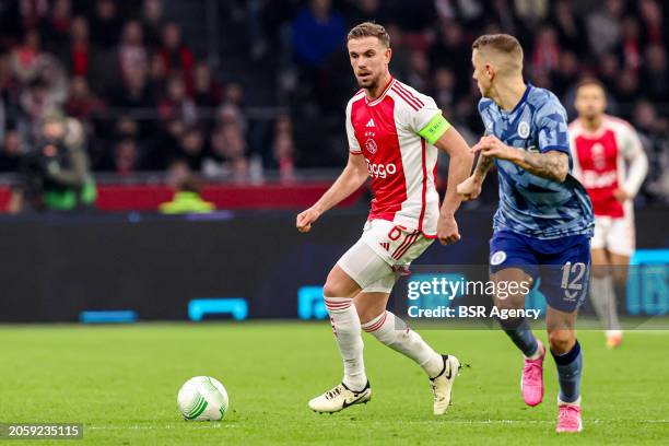 Jordan Henderson of AFC Ajax battles for possession with Lucas Digne of Aston Villa FC during the UEFA Europa Conference League Play Offs match...