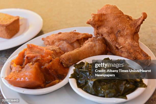 Chris's famous fried chicken, collard greens and candied yams served with a corn muffin at Chris's Southern Connection on Madison Ave. On Wednesday,...
