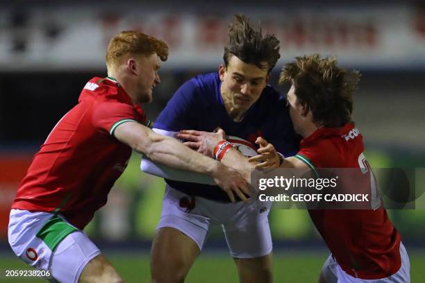 France U20's wing Nathan Bollengier is tackled by Wales U20's wing Walker Price and Wales U20's Aidan Boshofff during the U20 Six Nations...