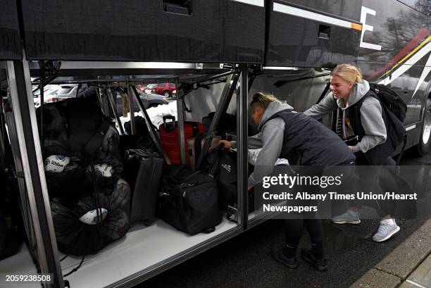 College of Saint Rose soccer players Ciera Lundy, left, and Sanna Rein load their luggage on the bus before the team leaves for national semifinals...