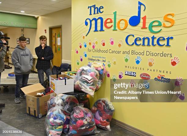 Year-old Dillon Speanburgh of Valley Falls, left, and Jeremy Wernick of Latham deliver 900 hats for patients at Albany Medical Center on Tuesday,...