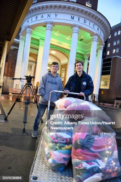 Year-old Dillon Speanburgh of Valley Falls, left, and Jeremy Wernick of Latham deliver 900 hats for patients at Albany Medical Center on Tuesday,...