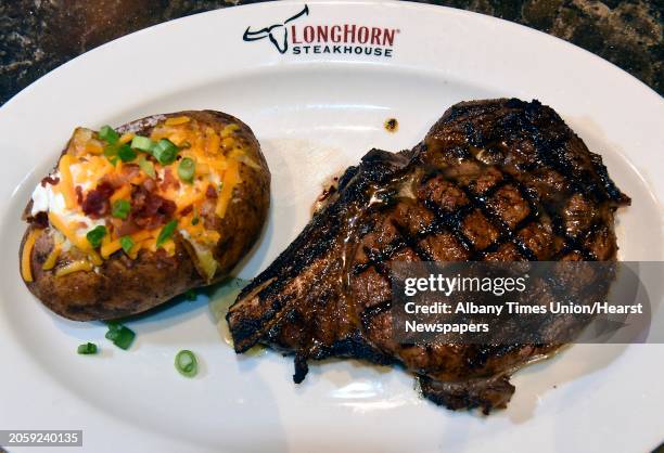 Outlaw ribeye - bone in, well-marbled, fire-grilled served with choice of side at LongHorn Steakhouse on Monday, Jan. 6, 2020 in Colonie, N.Y.