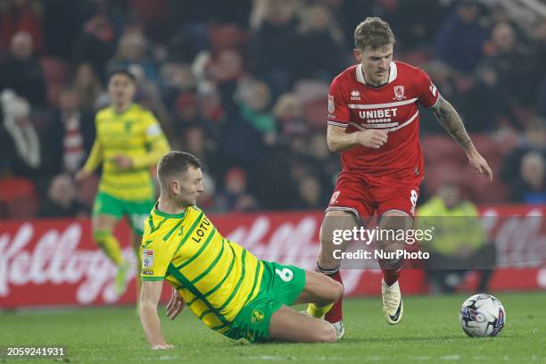 Riley McGree of Middlesbrough is skipping through a tackle by Ben Gibson of Norwich City during the Sky Bet Championship match between Middlesbrough...